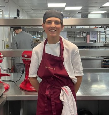 Nate smiling in a professional kitchen
